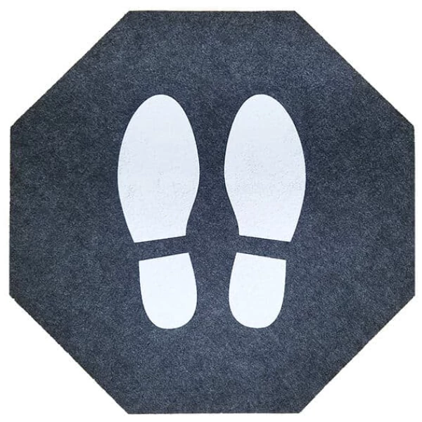 Stick and Stand Isolated full mat 900x600 1 Floormat.com Stick-and-Stand mats are adhesive-backed social distancing mats designed to mark a safe place for customers to stand while waiting in lines. <strong>Sold by case only, with 6 mats per case.</strong> <ul> <li>Universal "stop sign" shape with shoe prints marks where customers should stand; mats can be placed at safe intervals in virtually any configuration.</li> <li>Adhesive backing keeps the mat flat and in place, even with heavy cart and buggy traffic.</li> <li>Mats can be left in place during daily floor cleaning; floor scrubbers, mops, and brooms will pass right over them without causing damage.</li> <li>Less likely than floor decals to leave a sticky residue.</li> <li>Treated with an anti-microbial formula for protection from odors.</li> <li>Low-profile design with a high-traction surface to enhance slip resistance.</li> <li>Mat lifetime is up to 3 to 4 months under normal use.</li> </ul>