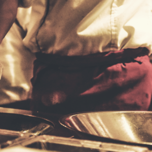 A chef is preparing food in a kitchen.