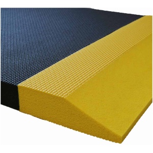 A yellow and black rubber mat on top of a white surface.