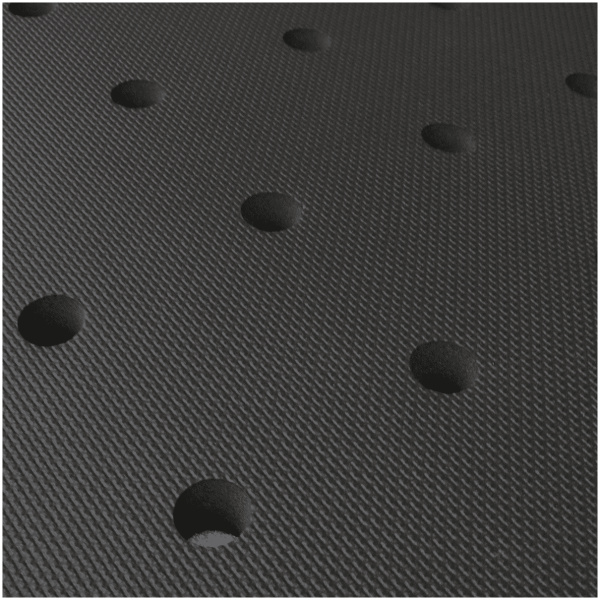 A close up of a black mat with holes in it.