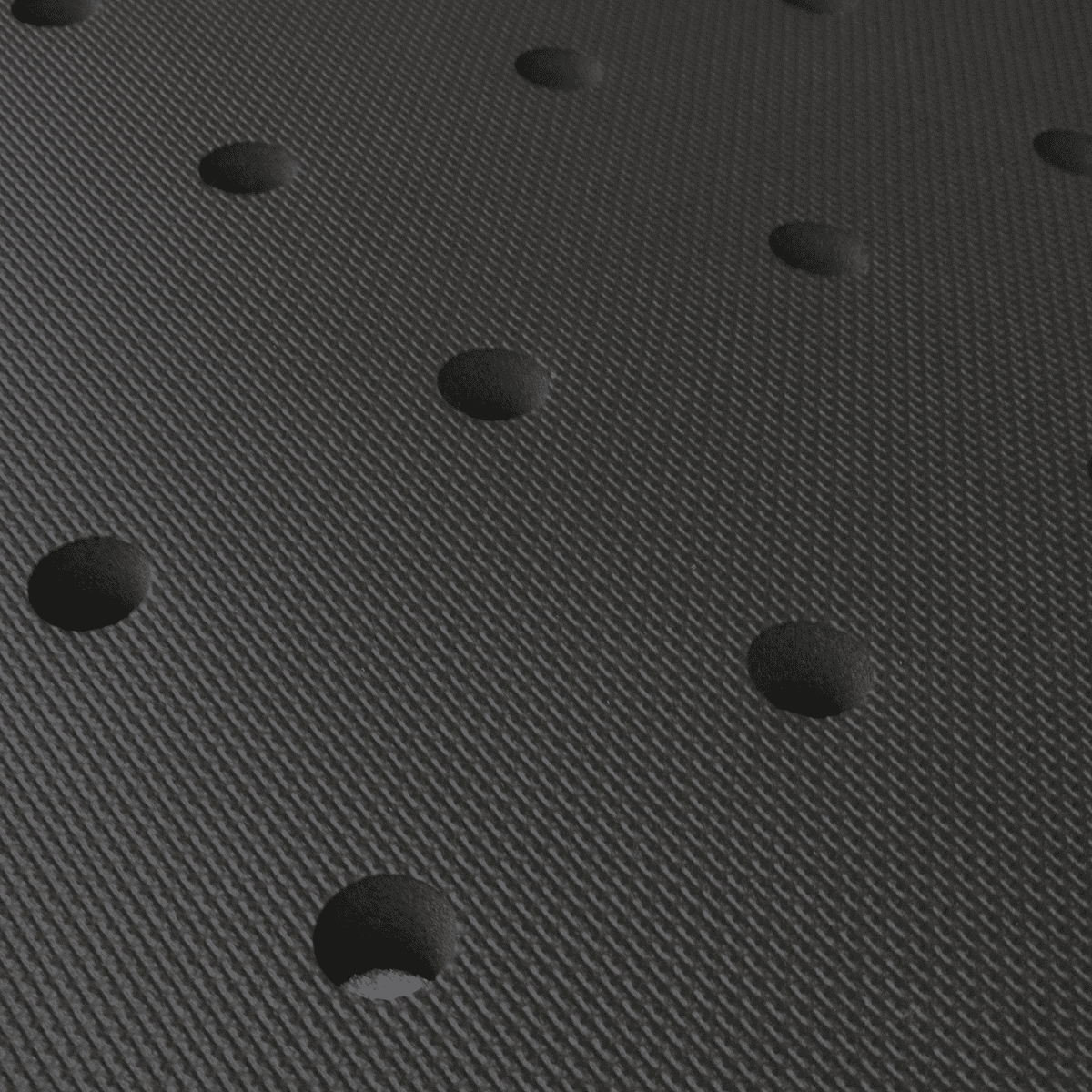 A close up of a black mat with holes in it.