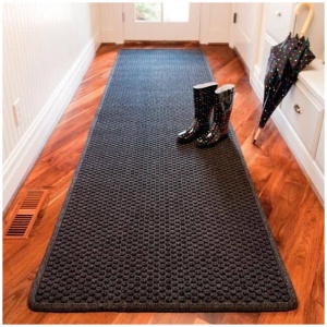 Aqua Trap Floor Mat supporting rain boots on an Aqua Trap Floor Mat runner rug in a hallway.
