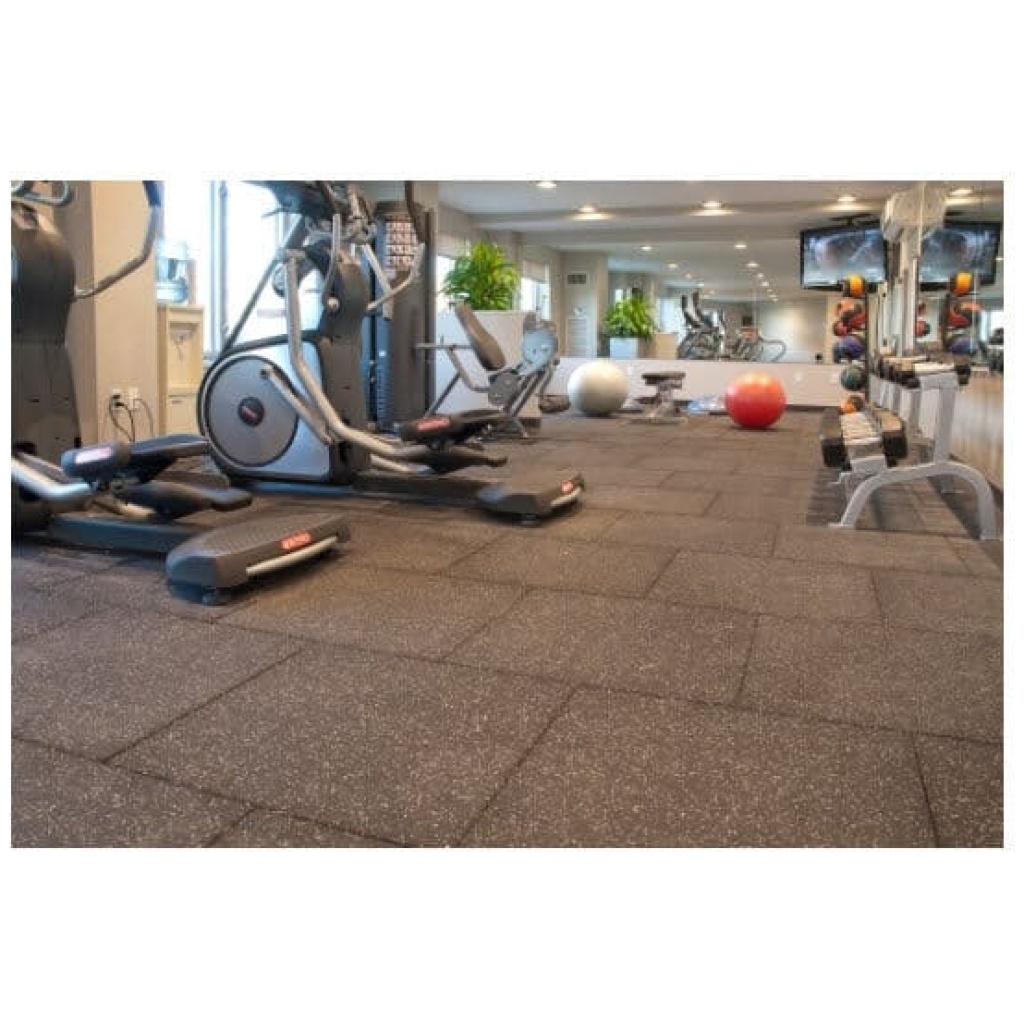 A gym room with a treadmill and other exercise equipment.