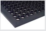 A black mat with holes on it.