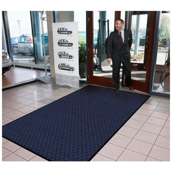 Evergreen Diamond 3 Floormat.com Evergreen Diamond™ features a fashionable diamond pattern design made from 100% recycled carpet fibers. A hefty 25 ounce per square yard tufted loop pile top surface allows the mat to capture debris and moisture while maintaining its attractive appearance. A heavyweight vinyl non-slip backing ensures minimum movement. <ul> <li>Carpet fibers made from 100% recycled material</li> <li>25 ounce tufted loop pile carpet for increased moisture retention</li> <li>3/8 inch overall thickness for use in narrow clearance doorways</li> <li>Vinyl backing helps reduce mat movement</li> </ul>
