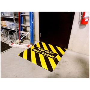 A hazardous Floormat Fire Exit Marker sign on a floor.