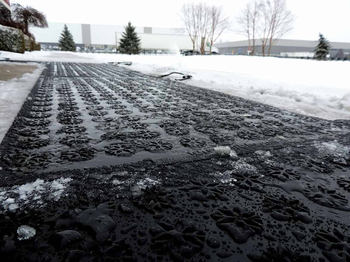 A walkway covered in Snow Melting Floor Mats effectively melts snow.