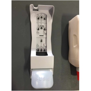 A dispenser for hand sanitizer on a wall.