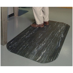 A man standing on a black marble floor mat.