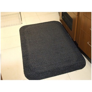 A kitchen with a black mat on the floor.