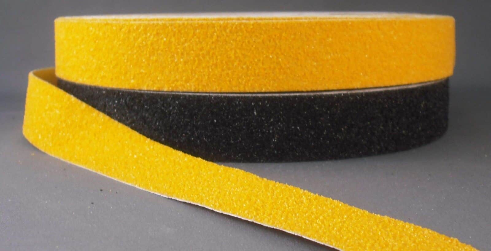 A yellow Floormat Anti Slip Tape on a grey surface.