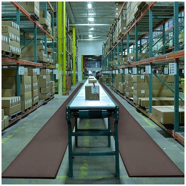 A warehouse with a lot of boxes on the floor.