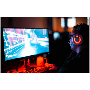 A man is using the ToastiMat Heated Mouse Pad while playing a computer game.