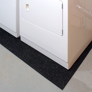 A laundry room with a washer and dryer equipped with noise reduction features.