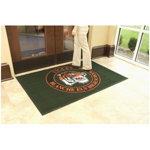 A woman standing in front of a door with a tiger logo on it.