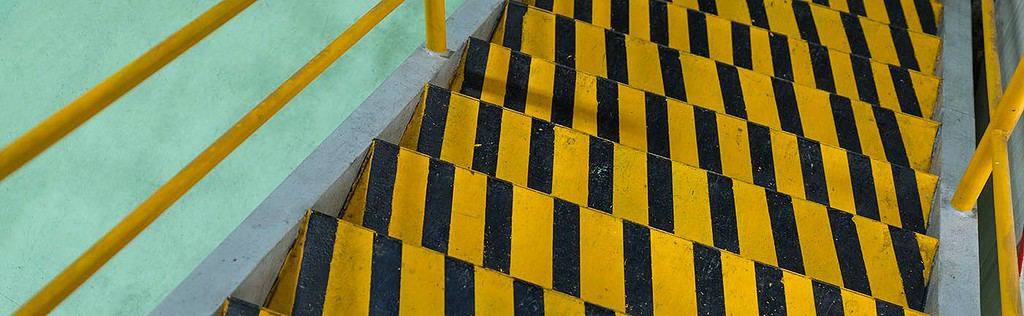 Yellow and black striped stairs in a building.