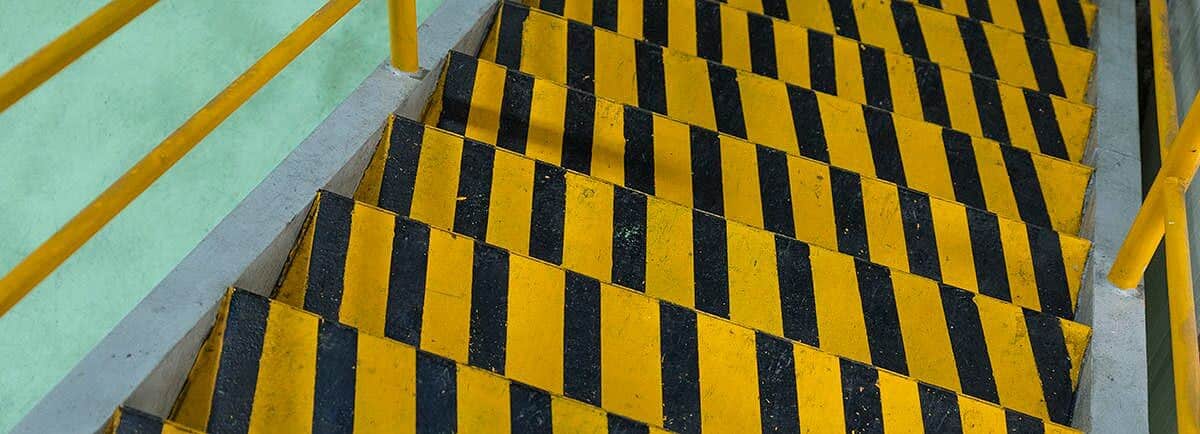 Yellow and black striped stairs in a building.