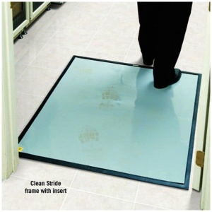 A man is using Clean Stride Dirt Removal Mat Frames while walking on a floor.