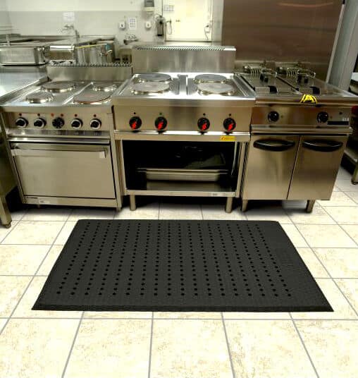 An image showcasing a Cushion Max floor mat in a kitchen setting.