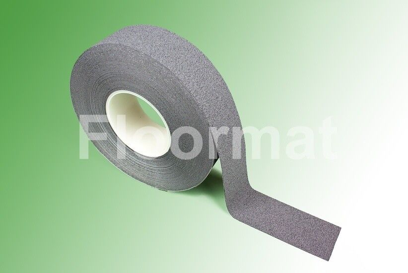 A roll of grey cushion grip tape on a green background.