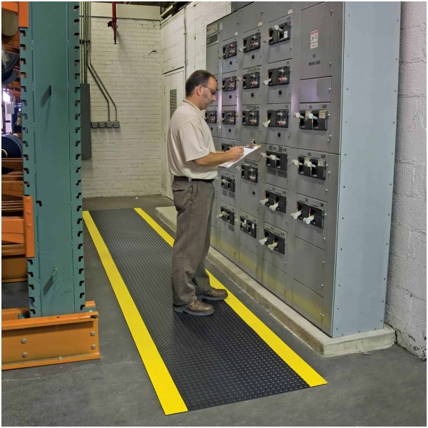 A man standing in front of an electrical panel, surrounded by Diamond SwitchBoard Matting Floor Mat.