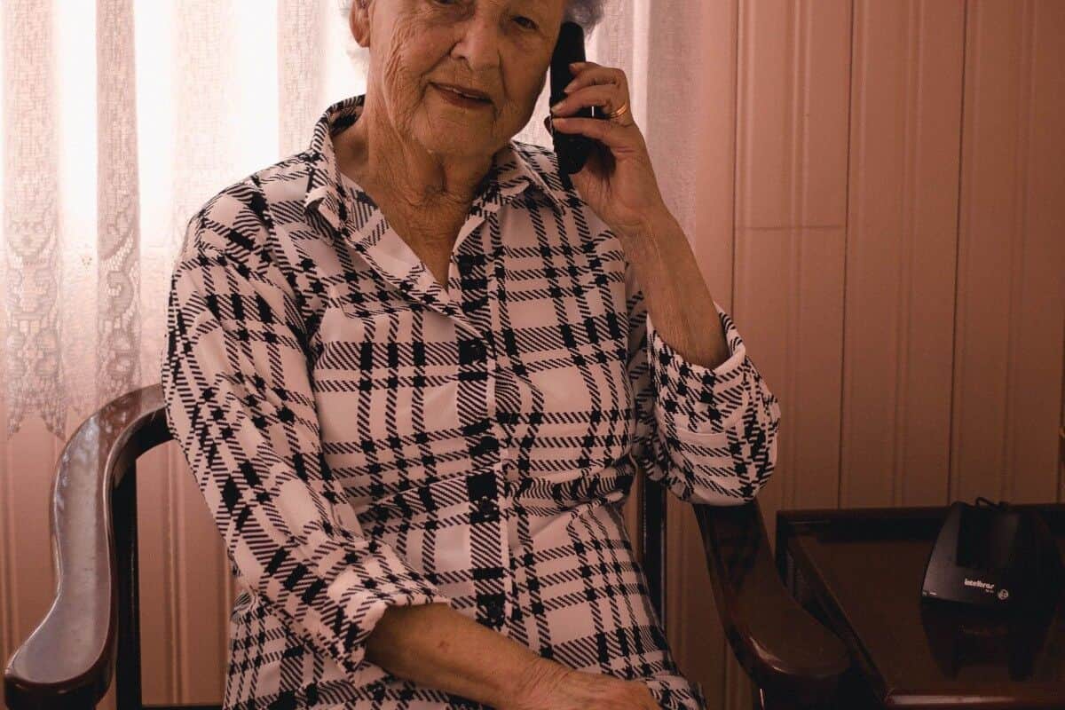 An elderly woman sitting in a chair and reducing fall risks.