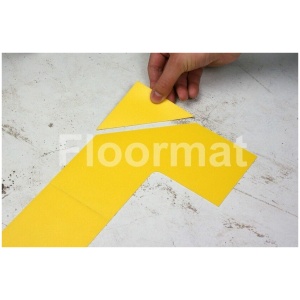 A person cutting a yellow piece of paper with End Caps Pallet Floor Markers.