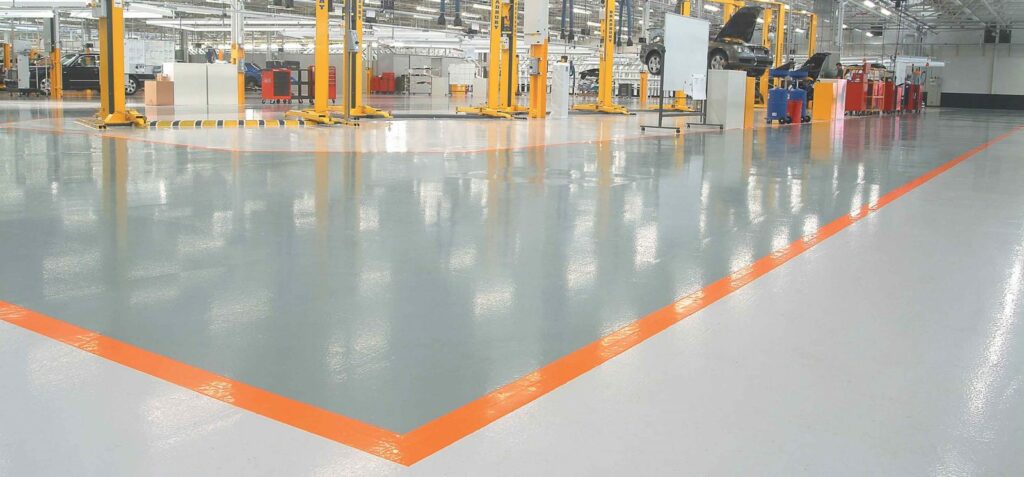 A factory with orange lines and heated floor mats.