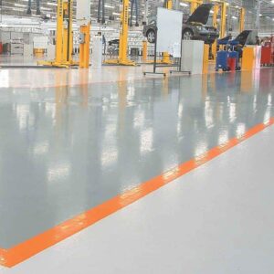A factory with orange lines and heated floor mats.