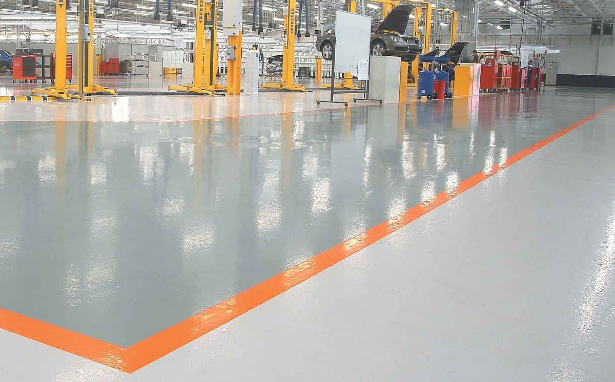 A factory with orange lines and heated floor mats.