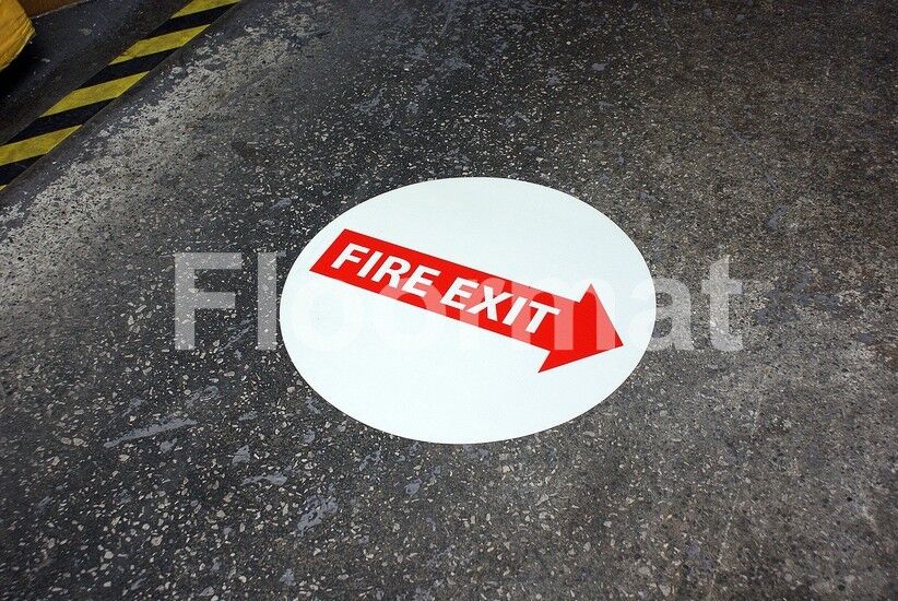A concrete floor with a Fire Exit Arrow sign.