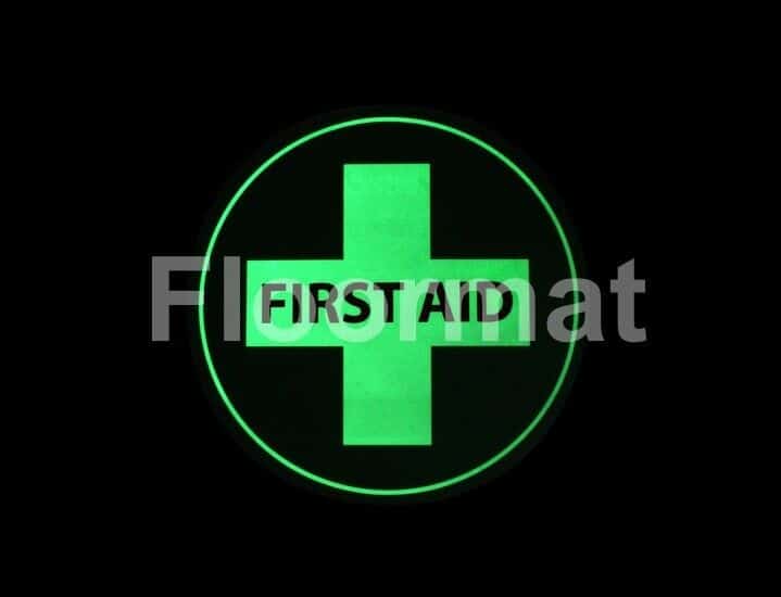 A First Aid Photoluminescent sign on a black background.