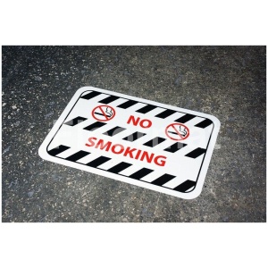 A "No Smoking" sign placed on a concrete surface.