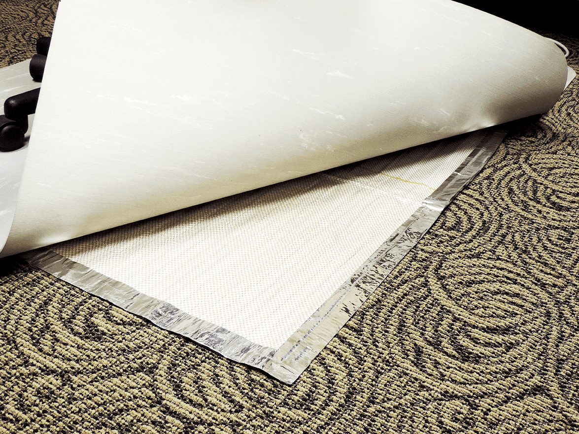 A roll of white paper on a Floormat Heated Chair Mat Kit.