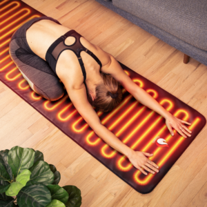 Woman practicing yoga on a ToastiMat Heated Yoga Floor Mat at home.