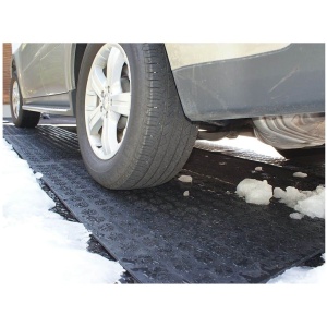 A HOTFlake Walkway / Driveway Mat is parked on a snowy driveway.