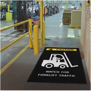 Safety Message Floor Mats with a forklift traffic sign is in a warehouse.
