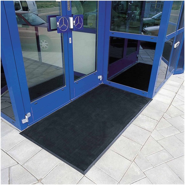 notrax 345 image 3 Floormat.com Rubber Brush™ mats are constructed of tough SBR rubber to remain flexible while withstanding extreme cold. Thousands of tough, flexible rubber fingers sweep shoes clean while suction cups on the underside of the mat help to minimize shifting. Due to its durable construction, Rubber Brush™ is the perfect year round outdoor entrance mat for schools, municipal buildings, plant entrances, and office buildings.