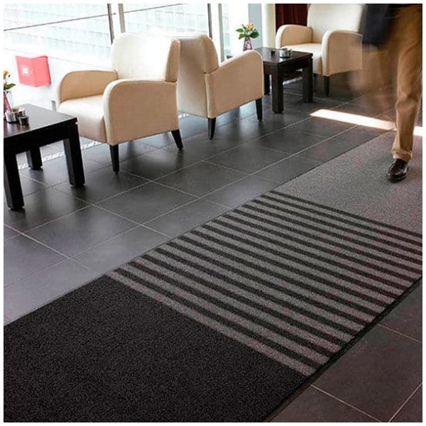 A man strolling through an Opera Floor Mat-themed lobby.