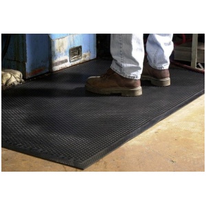 A person standing on a Safety Scrape Floor Mat in a garage.