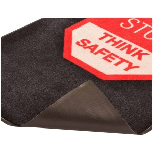 A black Safety Message Floor Mat with a stop think safety sign on it.