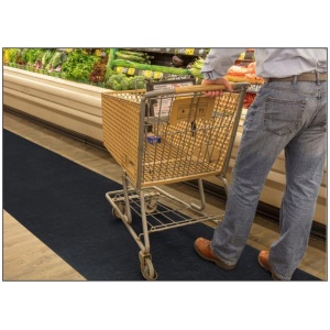 A man effortlessly navigating a grocery store aisle with a shopping cart equipped with a Sure Stride Floor Mat.