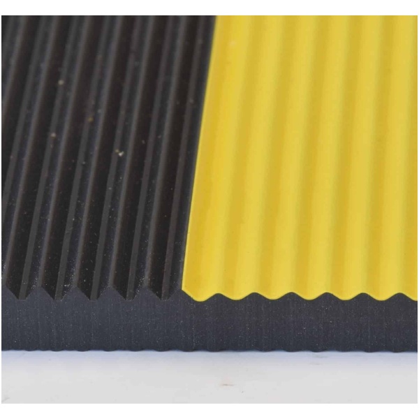 A yellow and black SwitchBoard Matting on top of a white surface.