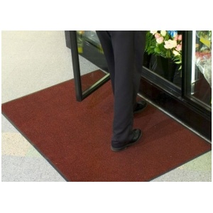 A man standing with a ColorStar Floor Mat in front of him.