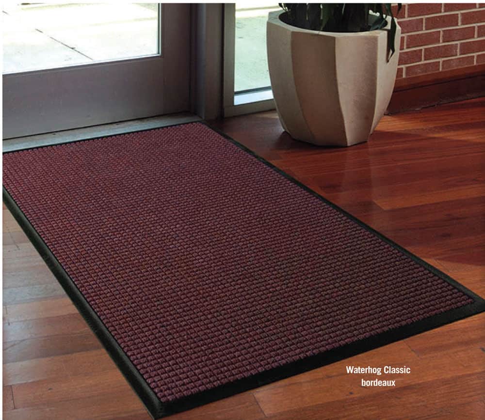 A WaterHog Classic floor mat with a red color on it.
Product Name: WaterHog Classic Floor Mat