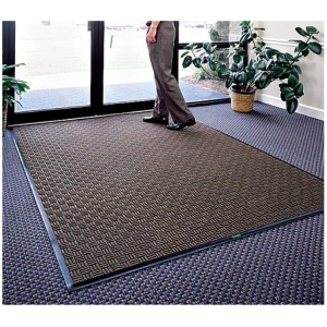 A person standing on a Waterhog Masterpiece Select Floor Mat in front of a Waterhog Masterpiece Select Floor Mat.