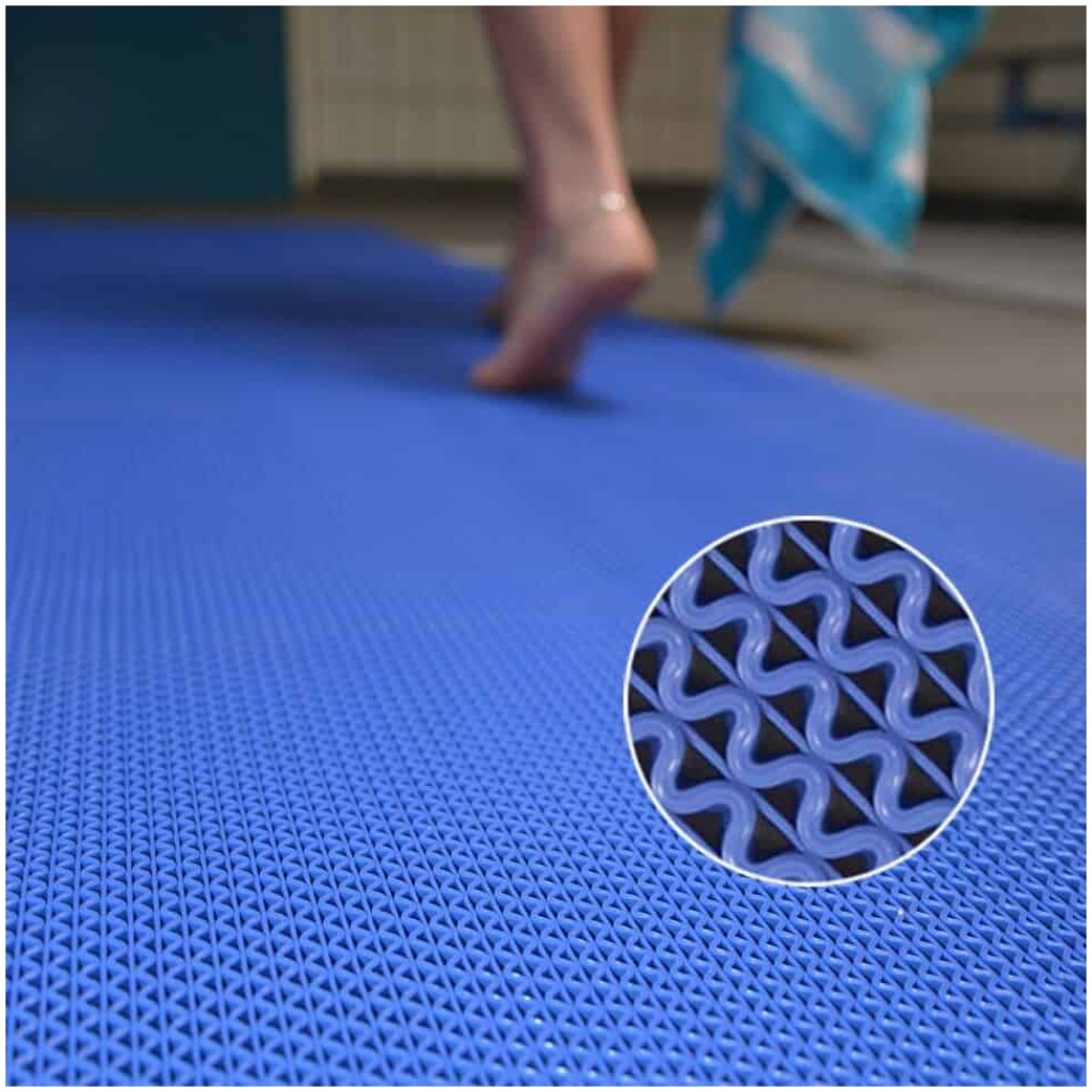 A person is standing on a mat in a swimming pool.